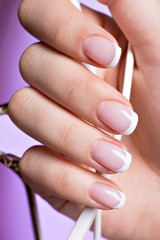 woman's nails with beautiful french white manicure