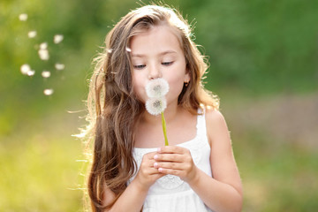 portrait of a beautiful little girl with flowers