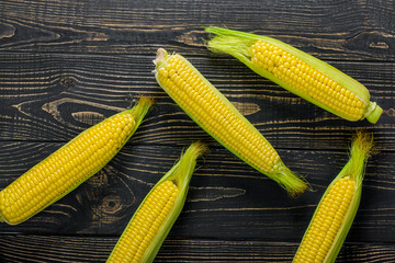 corn cobs on vintage wood as background