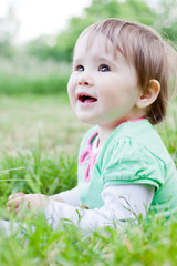 Cute little girl on the meadow in spring day.