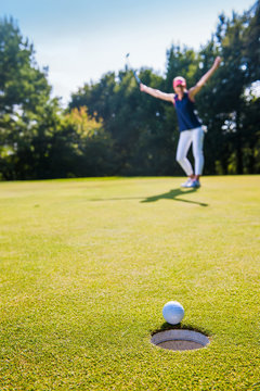 a ball is about to drop in the hole Close up on a winning swing