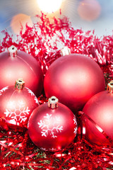 Xmas red baubles and tinsel on blue background