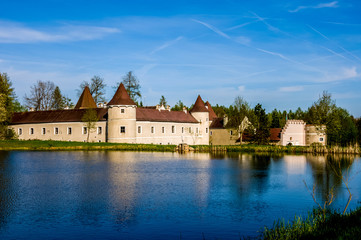 Naklejka na ściany i meble A calm lake in the foreground and castle Waldreichs (german Schloss Waldreichs) in the background. 