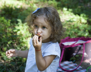 child eat outdoors