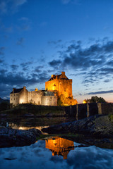 Lake mirroring at dusk of Eilean Donan Castle, Highlands, Scotland - 90424116