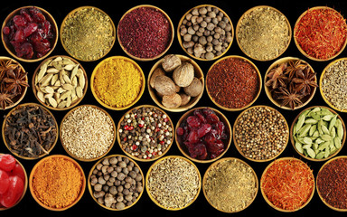 Different spices on black background
