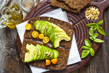 sandwich with rye bread on a board for cutting: avocado, yellow © irynagrygorii