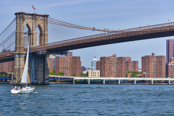 Boat Sails under Brooklyn Bridge