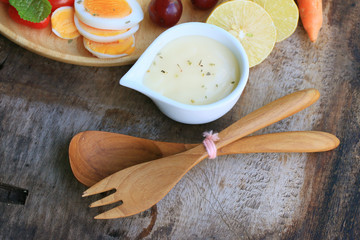 fresh red spinach salad and cream on wooden table