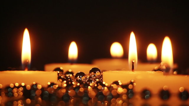 Burning candles close-up seamless loop