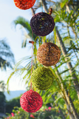 Decoration made of thread balls in front of palm trees