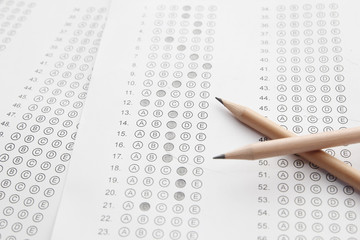 Standardized test form with answers bubbled in and a pencil, foc