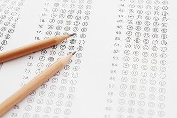 Standardized test form with answers bubbled in and a pencil, foc