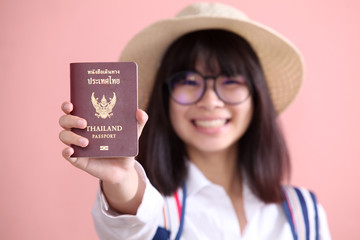 Asian girl holding passport to travel