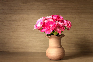 the Fresh pink carnation flower on wooden shelf background