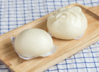 White Steamed buns on wooden tray