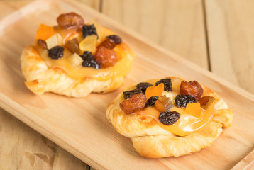 Danish custard with mixed dried fruit on wooden dish