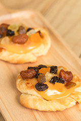 Danish custard with mixed dried fruit on wooden dish