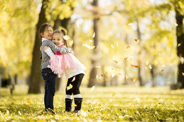 Two little girls at the autumn park