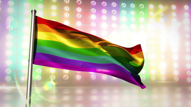 Rainbow flag blowing against flashing lights