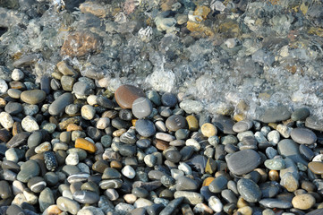 small pebbles and surf of the sea - background image