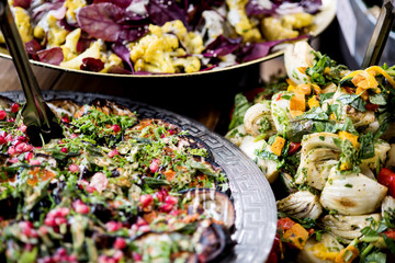 An assortment of salads on a buffet table