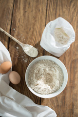 top view, ingredients to make a cake on a wooden table