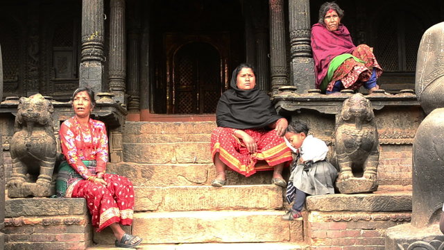 Womens sit on the steps of the temple
