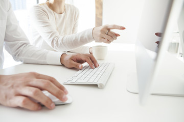 Fototapeta premium Men and women are looking at the computer monitor together