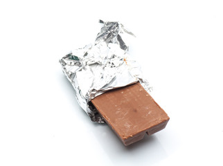 Chocolate bar with open aluminium wrapper