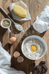 top view, ingredients to make a cake on a wooden table