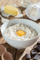 ingredients to make a cake on a wooden table