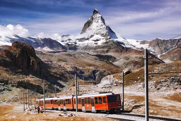 Papier Peint photo Cervin Famous Matterhorn peak with a train in Swiss Alps, Switzerland