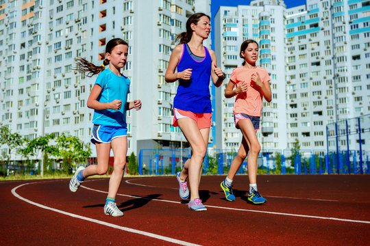 Family Sport, Happy Active Mother And Kids Jogging On Track, Running On Stadium