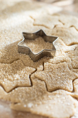 close up of a cookie cutter and a cake dough
