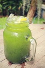 Ice green tea with lemon on a jar
