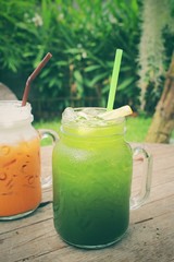 Ice green tea with lemon on a jar