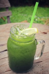 Ice green tea with lemon on a jar