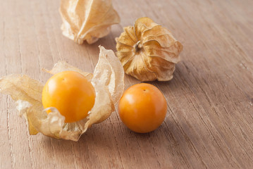 Cape gooseberry (Physalis) on wooden table, healthy fruit and ve