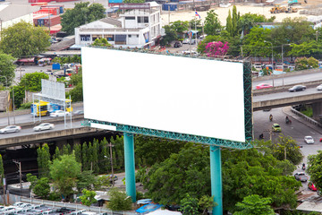 Big white billboard on highway.