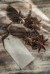 star anise on wooden background with blank label