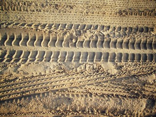 Wheel tracks on the soil.