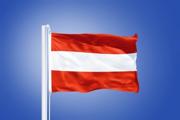 Flag of Austria flying against a blue sky