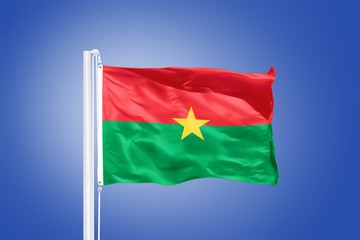 Flag of Burkina Faso flying against a blue sky