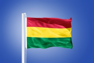 Flag of Bolivia flying against a blue sky