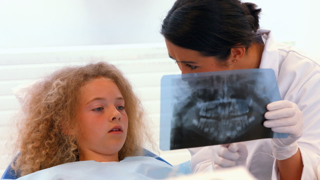 Dentist showing a patient an xray of teeth