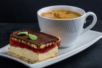 Cup of espresso coffee with homemade cakes on a plate