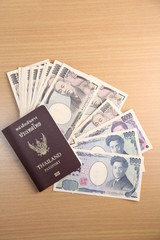 Japanese Yen banknote and Thai passport