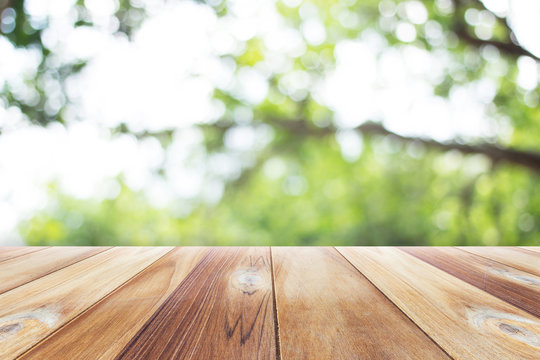 Close up wooden table with nature blurred background