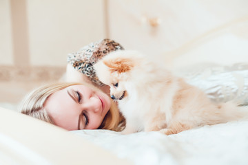 Beautiful Blonde Woman with Her Dog in a Beautiful Interior